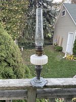 Full view of Aladdin lamp showing glass chimney, milk glass font, metal pedestal base