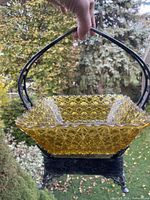 Overall view of amber glass insert in silver carriage, handle raised
