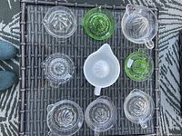 Top view of nine glass juicers arranged on table