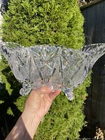 Side profile of clear cut crystal oblong bowl on four feet