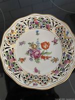 Full view of porcelain bowl showing reticulated rim and floral center