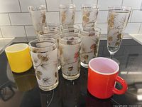 Group shot showing all 12 pieces: 4 pilsners, 6 tallboys, 2 mugs