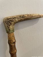 Close-up of light-colored wooden handle showing grain and wear