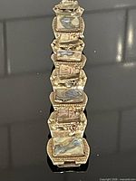Entire bracelet laid flat showing all seven abalone links