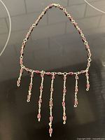 Full view of garnet lavaliere necklace showing chain and graduated drops