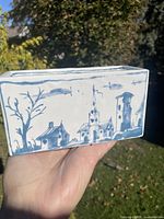 Side view showing village scene on blue and white porcelain brick
