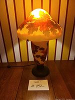 Full view of cameo glass table lamp illuminated