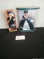 Both boxed dolls side by side for scale and contents overview