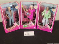 Group shot of three sealed Barbie The Movie dolls