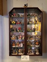 Full view of wall cabinet filled with figurines