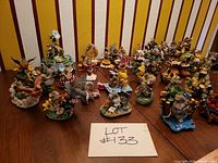 Overview of approximately 38 Charming Tails figurines on table