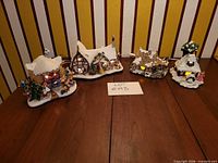 All four illuminated cottages displayed on table