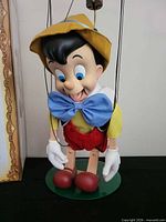 Front view of Pinocchio marionette on stand