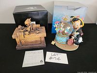 Full lot showing both Pinocchio pieces, certificate and boxes