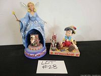 Both figurines side by side showing scale and bases