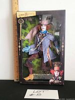 Front view of sealed Disney Alice in Wonderland Mad Hatter Barbie Collector doll box with ruler for scale