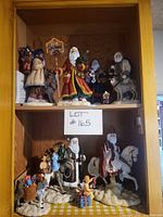 Overview of two shelf levels showing all figurines and certificate
