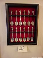 Framed set showing all 12 spoons in display