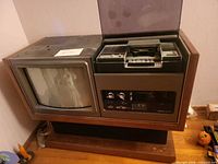 Front view of Sony wood console CRT TV with integrated Betamax VCR under open lid