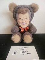 Front view showing entire plush bear and ribbon