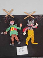 Both marionettes with crossbars and strings visible