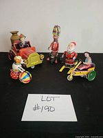 Group shot of all five tin wind-up toys