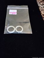 Pair of aventurine rings in plastic bag