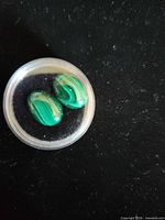 Two malachite cabochons in plastic case