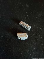 Two black tourmaline shards on dark background