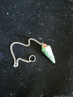 Bloodstone pendulum laid flat showing full chain and cone