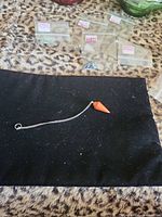 Full view of carnelian pendulum on black cloth