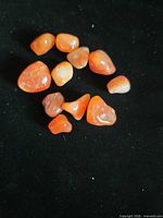 All carnelian stones together on black background