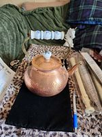 front view of hammered copper kettle showing ceramic handle and lid knob