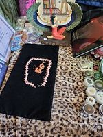 Necklace and earrings laid on black fabric