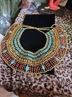 Full view of beaded Egyptian collar necklace on display pad