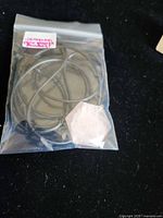 Pendant and cord sealed in plastic bag