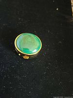 Top view showing malachite cabochon inset in gold-tone frame