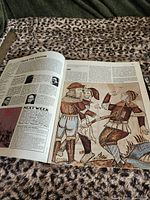Open spread of one magazine showing editorial content and medieval illustration