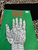 Front cover of Man Myth & Magic issue 76 showing title and illustrated hand