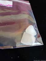 Two moonstones inside clear plastic bag