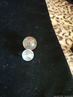 Both quartz spheres on black fabric