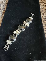 front view of bracelet showing stones, pearls and clasp