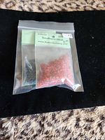 Sealed bag showing both red resin and smaller dark resin bag inside with label