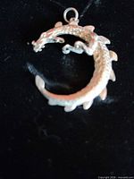 Front view of sterling silver coiled dragon pendant