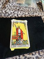 Front of tuck box featuring The Magician card artwork