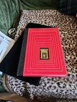 Front cover showing red hardcover with gold design