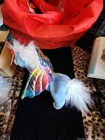 left side view of Ty Pegasus plush showing rainbow wings and tail