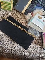 Full view of twisted unakite chip bead necklace on black cloth