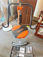 Full view of AbDoer Twist trainer with manuals on floor