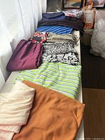 Row of folded fabrics in assorted colors and patterns